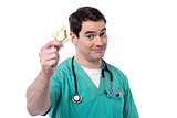 Doctor holding condom over white
