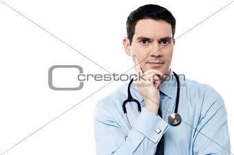 Pensive physician looking at camera
