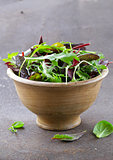 mix salad (arugula, iceberg, red beet) in a wooden bowl