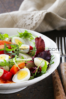 Easter Spring salad with quail eggs, tomatoes and cucumbers