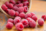 Fresh and tasty raspberries on a wooden table