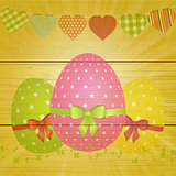 Easter eggs and bunting on wooden background