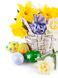 Easter eggs with spring flowers in basket