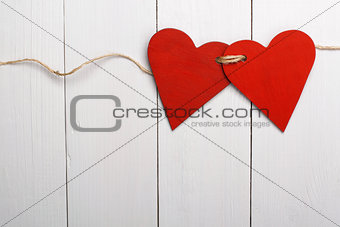 Two red hearts tied together. Valentine Day.