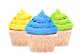 Three cupcakes with yellow, blue and green icing
