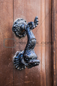 Old doorhandle in the form of an iron fish