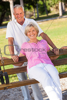 Happy Senior Couple Smiling On Park Bench