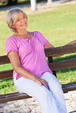 Portrait Happy Senior Woman Sitting Outside