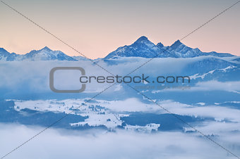 Alps in morning winter fog