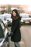 Stylish Woman Opening her Car at the Street Side