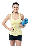 Fit woman with a gym mat