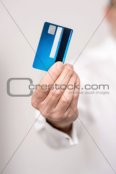 Male hand holding a new cash card