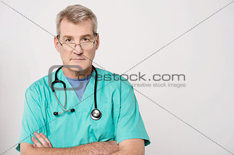 Senior doctor looking at camera