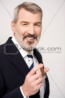 Happy businessman with cigar