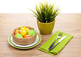 Easter eggs with silverware and potted flower