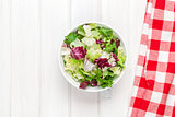 Fresh healthy salad over white wooden table