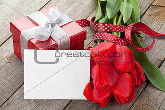 Fresh tulips, gift box and greeting card