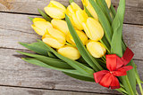 Fresh yellow tulips bouquet over wooden table background