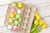 Easter background with colorful eggs and yellow tulips