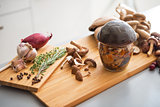 Closeup on jar of pickled mushroom on cutting board