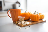 Closeup on small pumpkins seeds and tea bag on table