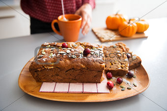 Closeup on freshly baked pumpkin bread with seeds and young hous
