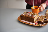 Closeup on freshly baked pumpkin bread with seeds and young hous