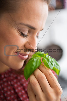 Young woman enjoying fresh basil