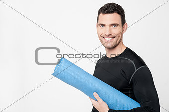 Gym instructor holding mat