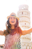 Happy young woman making selfie in front of leaning tower of pis