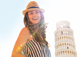 Portrait of smiling young woman in front of leaning tower of pis