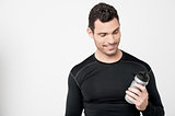 Fitness man looking his sipper bottle
