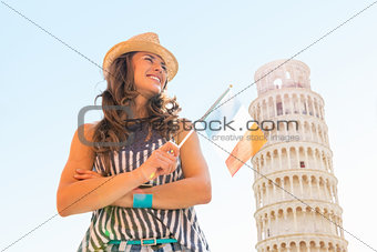 Happy young woman with italian flag in front of leaning tower of