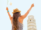 Young woman with italian flag rejoicing in front of leaning towe