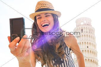 Happy young woman making selfie in front of leaning tower of pis