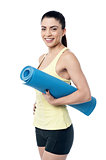 Beautiful woman with a yoga mat