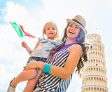 Portrait of happy mother and baby girl with italian flag in fron