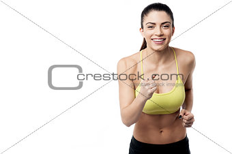 Athletic woman running in sports outfit