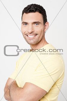 Handsome man posing with folded arms