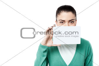 Woman with business card over white
