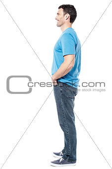 Full length of casual man posing side ways