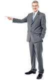 Happy businessman pointing on copy space