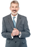 Businessman posing with clasped hands