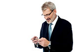 Senior businessman reading a text message
