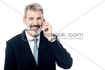Happy mature man talking on cell phone