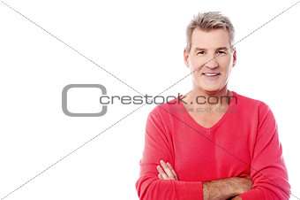 Handsome senior man posing with arms folded