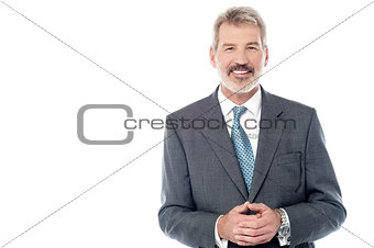 Businessman in suit with hands clasped