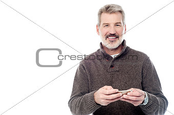 Smiling mature man with mobile phone