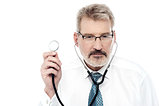 Senior doctor holding a stethoscope