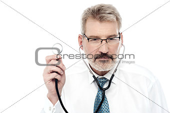 Senior doctor holding a stethoscope